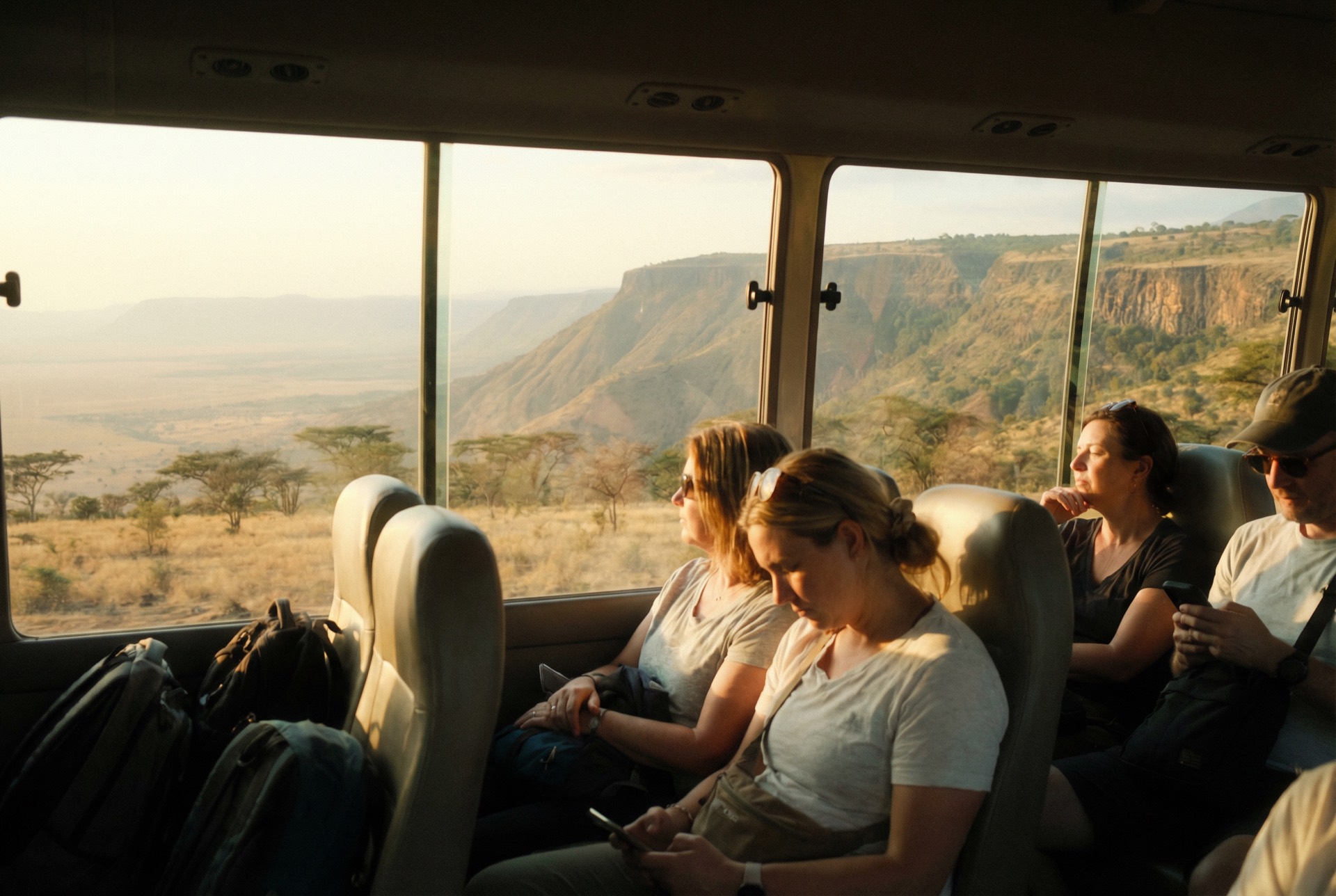 Passengers relaxing aboard a Riverside shuttle, looking out over the Rift Valley.